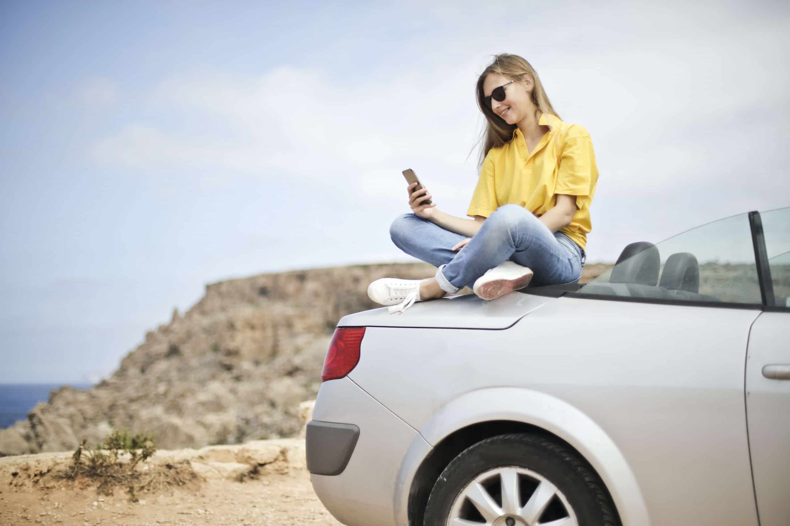 Online Car Title Loans in Florida 1 girl sitting on car