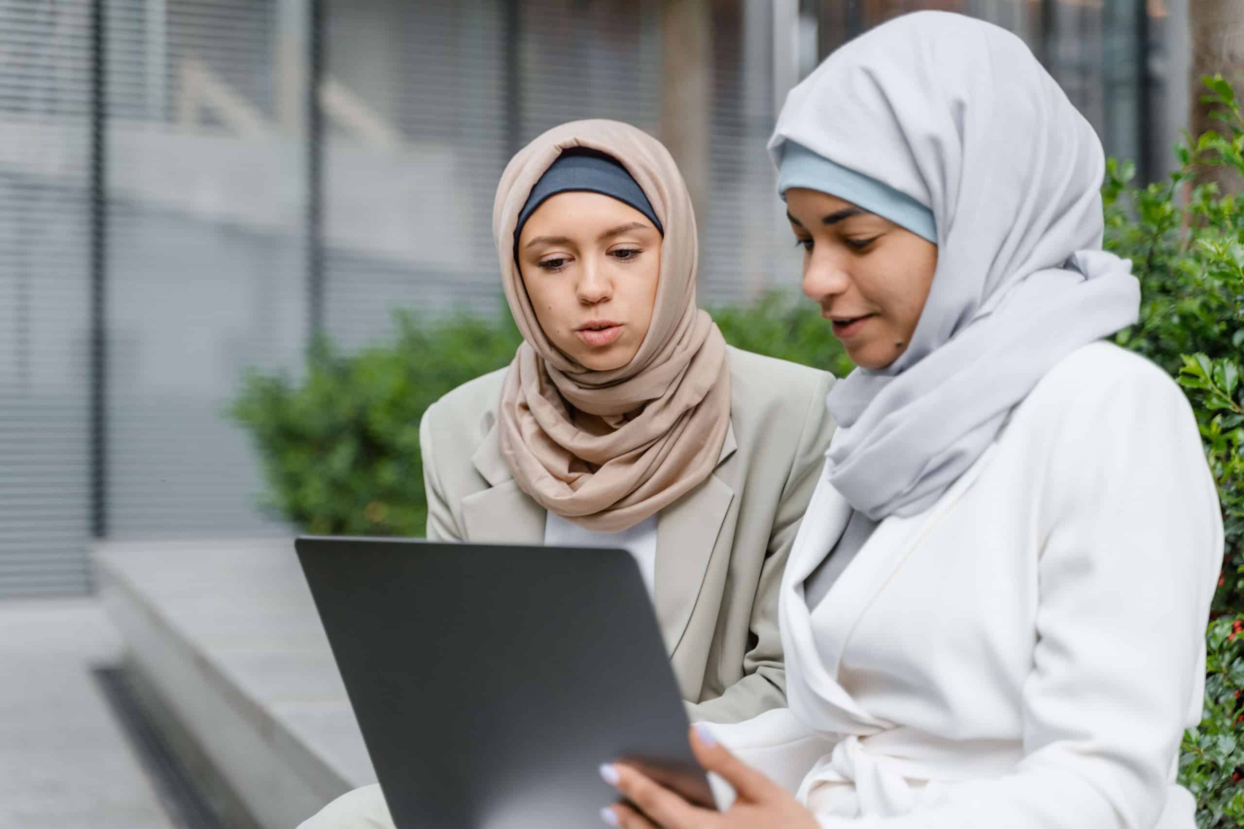 Woman in hijabs looking at computer