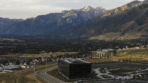 Get Fast, Emergency Title Loans in Lehi, Utah Modern office building sits at the base of snow-capped Wasatch Mountains in Lehi, Utah.