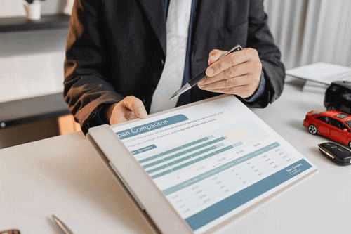 Loan agent calculating loan details and reviewing financial documents