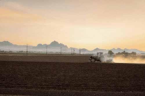 An Arizona farmer working his fields on a hot spring day near Marana, Arizona
