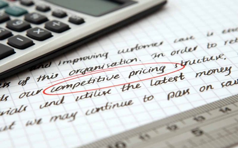 texas-austin Calculator on piece of paper with competitive pricing written